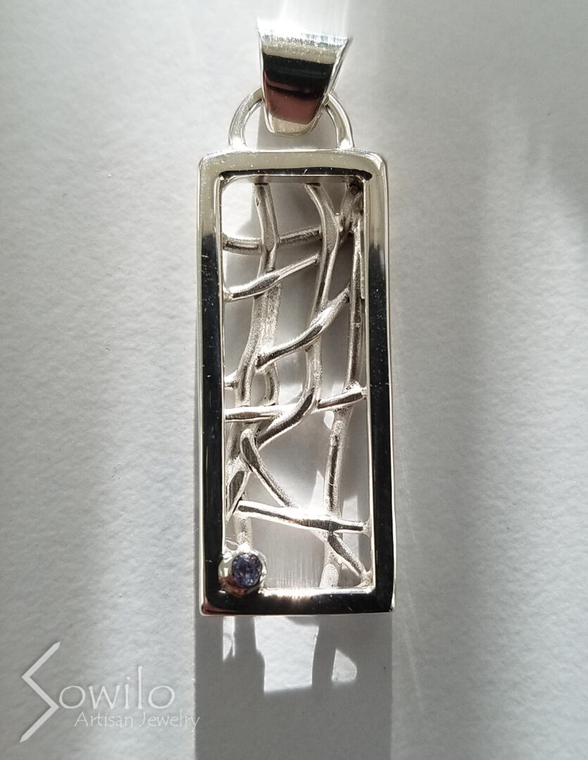 A long silver pendant