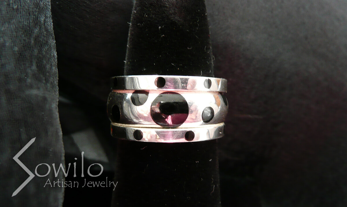 A polka-dotted silver ring