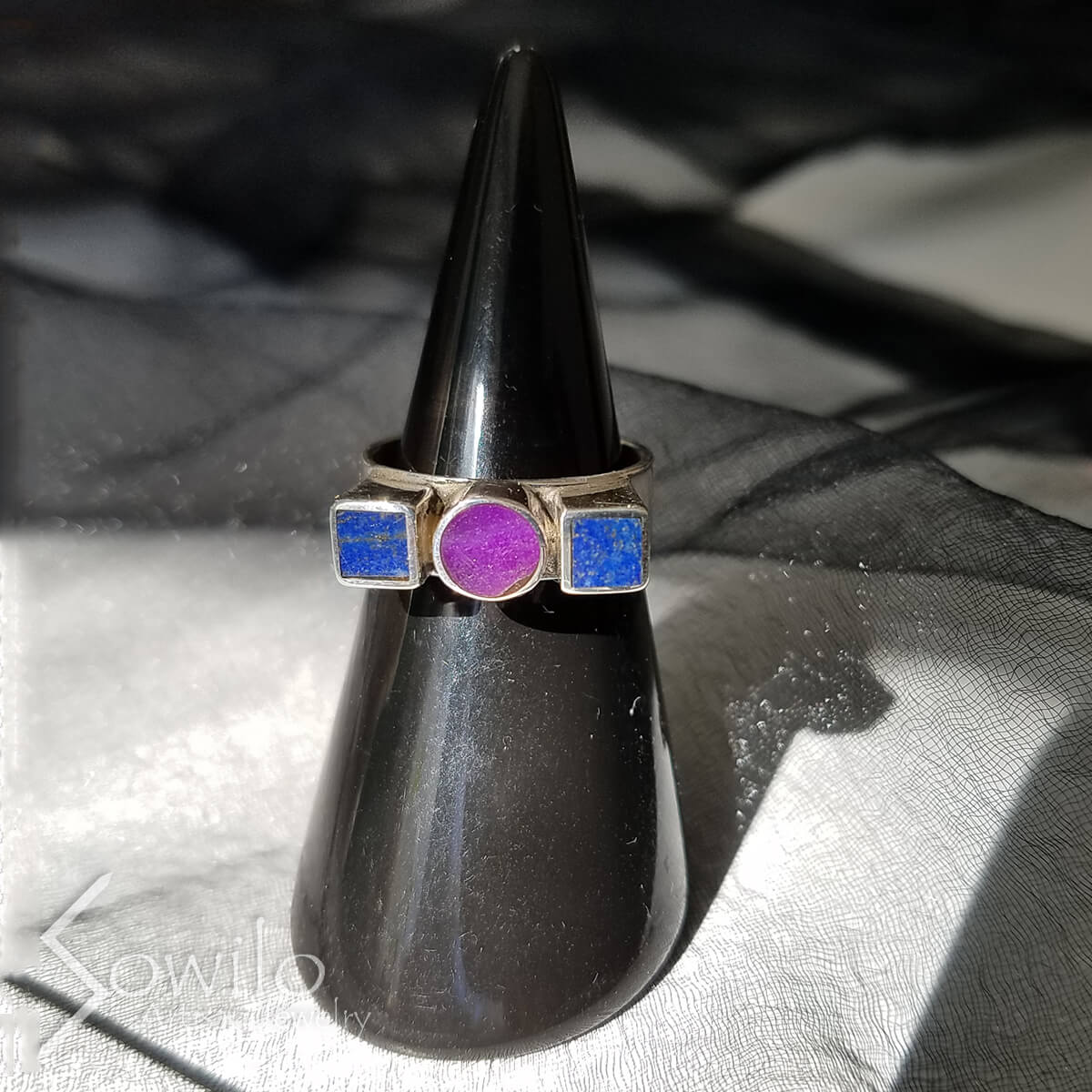 A silver ring with blue and purple stones