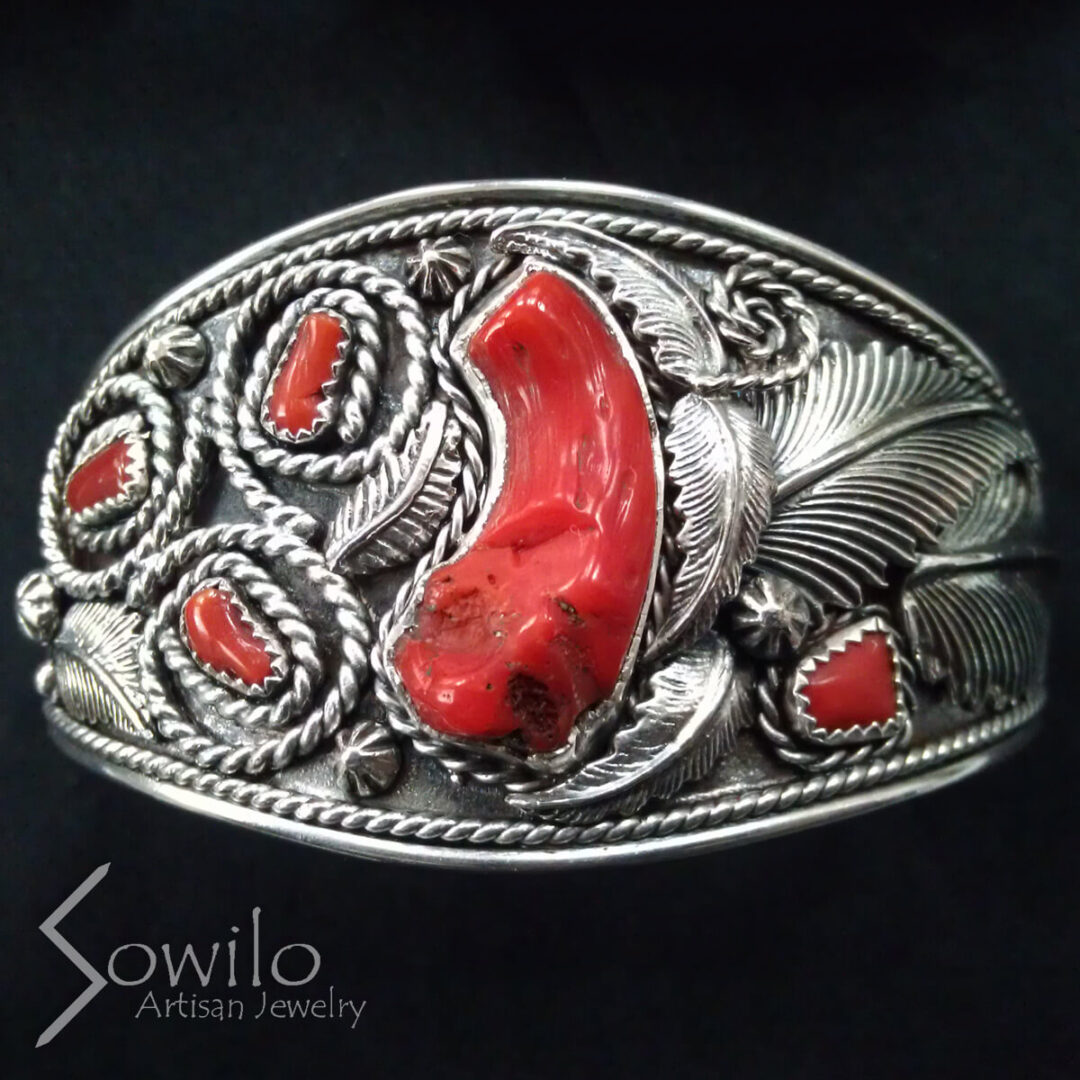 A silver cuff with red stones